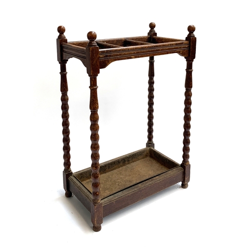 208 - An oak umbrella/stick stand, three divisions, with drip tray, 71cm high