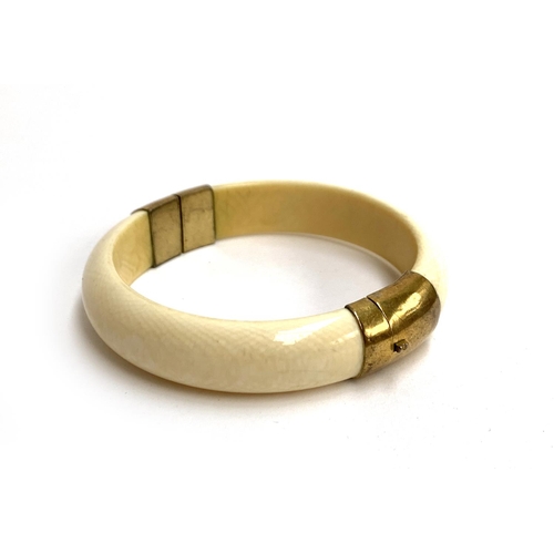 79 - A 19th century ivory and brass bangle, 7.5cmD