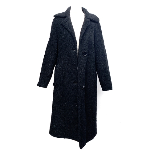 913 - A vintage black lambswool overcoat with quilted lining, approx. size 10; together with a 1970s vinta... 