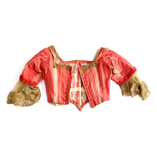 925 - A 19th century pink silk jacket with whalebone, and lace trim