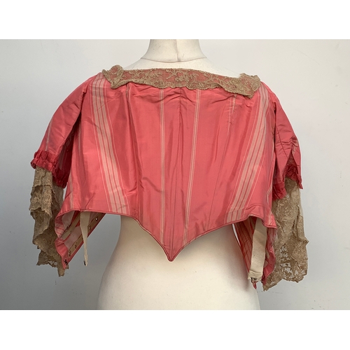 925 - A 19th century pink silk jacket with whalebone, and lace trim