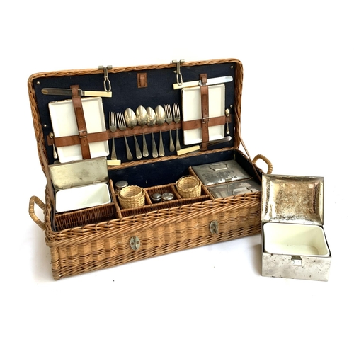 1049 - A vintage wicker picnic hamper, with fitted interior with contents, including four ceramic lined tin... 