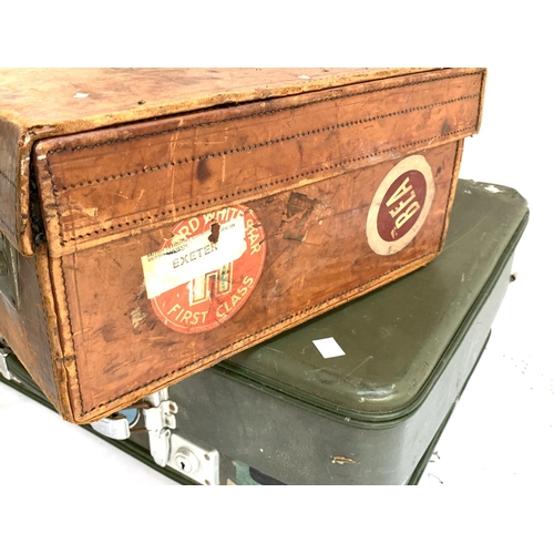 1050 - A Revelation 'Silverline' vintage suitcase; together with a vintage brown leather suitcase, with tra... 