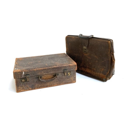 1060 - A vintage leather suitcase, 51cmW, with silk lined interior; together with a large leather briefcase... 