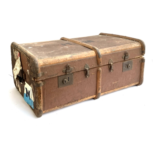 1063 - A vintage canvas and bamboo banded travel trunk, withs stickers, top monogrammed H.M, 77x50x33cm