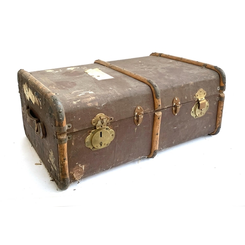 1064 - A vintage canvas and bamboo travel trunk, with side handles, the sides monogrammed H.M, 77x54x33cm