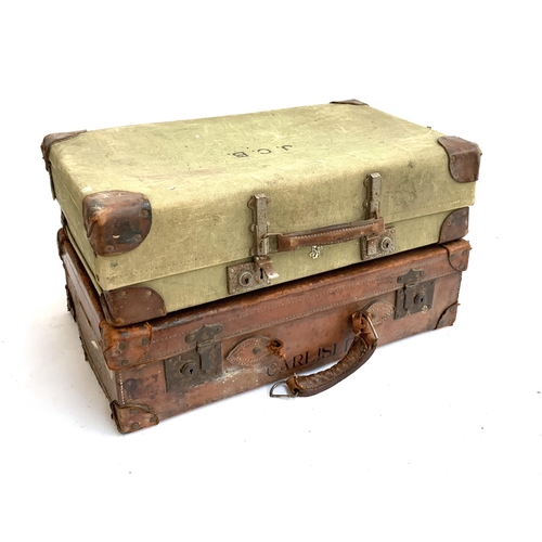 1066 - A vintage leather suitcase, marked Carlisle, 67x40x19cm; together with one other, vintage canvas and... 