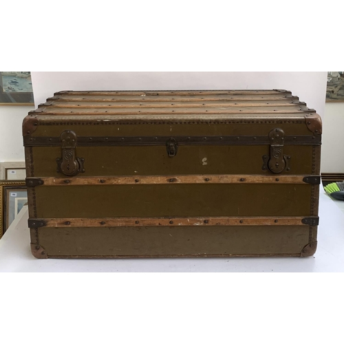 1067 - A large canvas and wood banded travel trunk by Ernst Ott, Wien V Castelig, handles af, leather corne... 