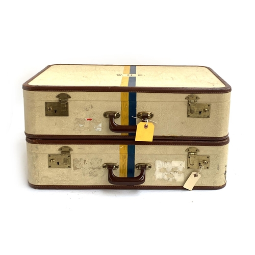 1071 - A pair of vintage suitcases, each initialled W.H.E, and painted with blue and yellow stripes, with k... 