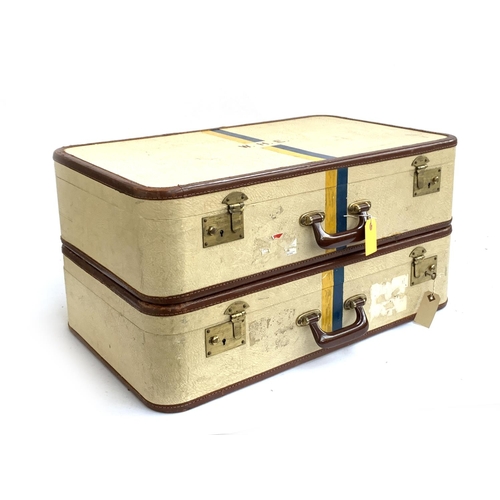 1071 - A pair of vintage suitcases, each initialled W.H.E, and painted with blue and yellow stripes, with k... 