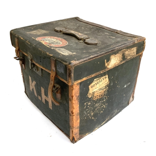 1075 - An early 20th century canvas and leather suitcase, with travel stickers, 46x36x41cm