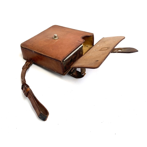 1083 - A plated sandwich box, in a fitted hard leather saddle case, 16x16x5cm, flask missing