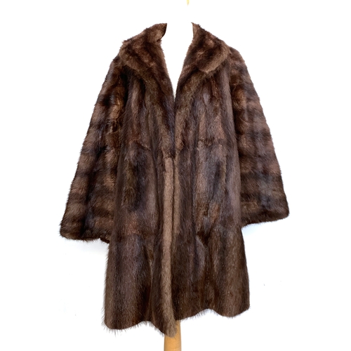 940 - A John Dunn & Sons fur coat with shawl collar, size 10-12