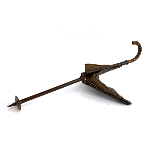 194 - In the style of Swaine & Adeney, a shooting stick with leather and canvas seat, the handle carved in... 