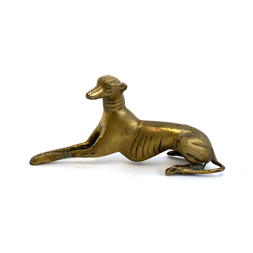 199 - A brass figure of a recumbent greyhound, 9.5cmH