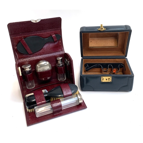 218 - A burgundy leather travelling vanity case with fitted interior, holding brushes, looking glass etc, ... 