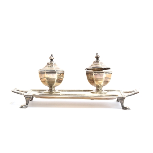 138 - A silver inkstand with two octagonal inkwells by Asprey, Sheffield 1911, each well with hinged lid a... 