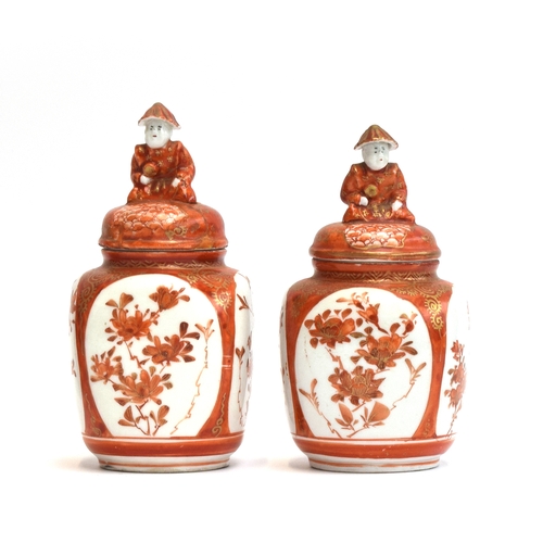 221 - A pair of Japanese Kutani vases, decorated with floral panels, each with figural finial to lid, mark... 