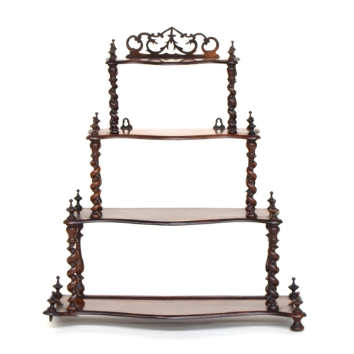 567 - A Victorian rosewood four tier whatnot, each shaped shelf on barleytwist supports, 68cm wide, 77cm h... 