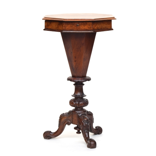 563 - A Victorian walnut octagonal work table, hinged lid with fitted interior, on a carved tripod base wi... 