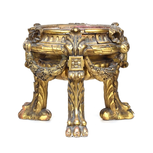 570 - A Continental giltwood occasional table, the top absent, having heavily carved acanthus and bows, al... 