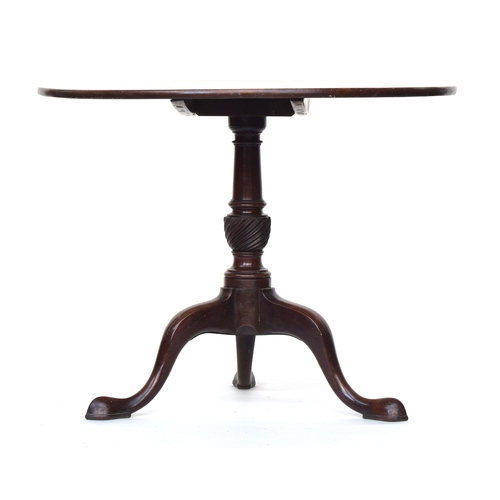 551 - A George III mahogany tip top table, on gun barrel column with wrythen carving, tripod cabriole legs... 