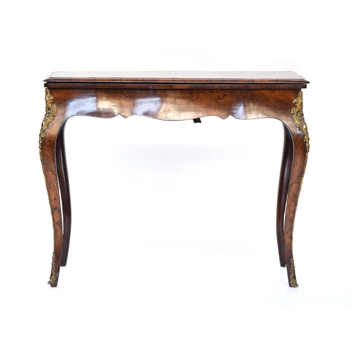 559 - A burr walnut and ormolu mounted swivel top card table, the shaped fold over top lined in green baiz... 