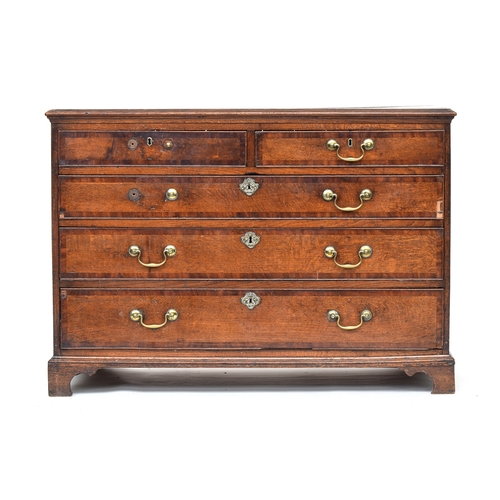 527 - A provincial George III oak and crossbanded chest of two short over three graduating cockbeaded draw... 