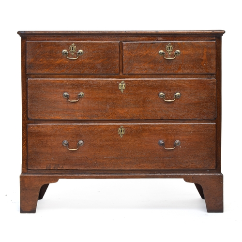 521 - A largely George II oak chest of two short over two long drawers, on later tall bracket feet, 96cm w... 