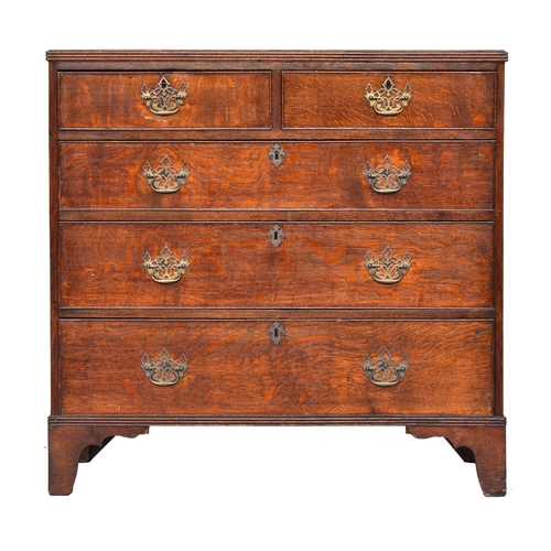 524 - A George III oak chest of drawers, the top with reeded edge over two short and three graduating cock... 