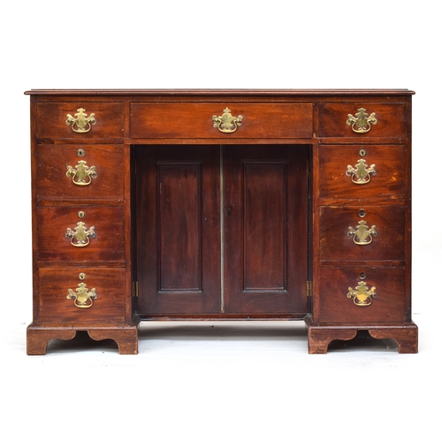 582 - A mahogany ladies kneehole dressing table, moulded top over an arrangement of nine drawers, the knee... 