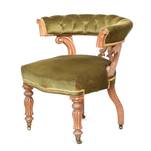 606 - A Continental carved desk chair, upholstered in green cord