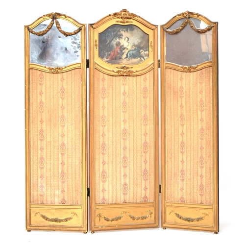 571 - A 19th century French three fold giltwood and gesso screen, the two outer panels with floral swags o... 