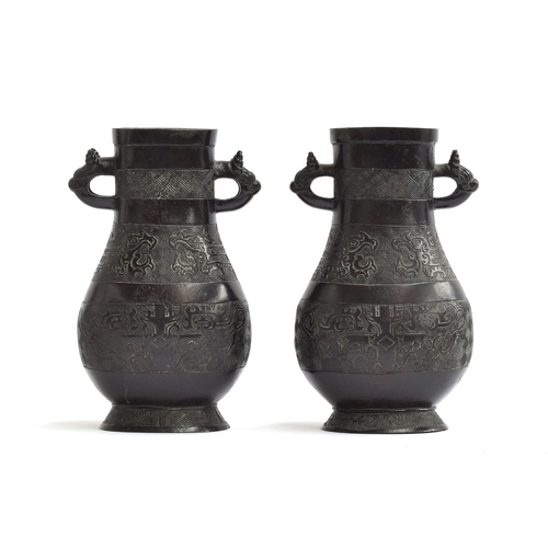 207 - A pair of Chinese Archaistic bronze vases, possibly Ming dynasty, each with horned dragon handles, c... 