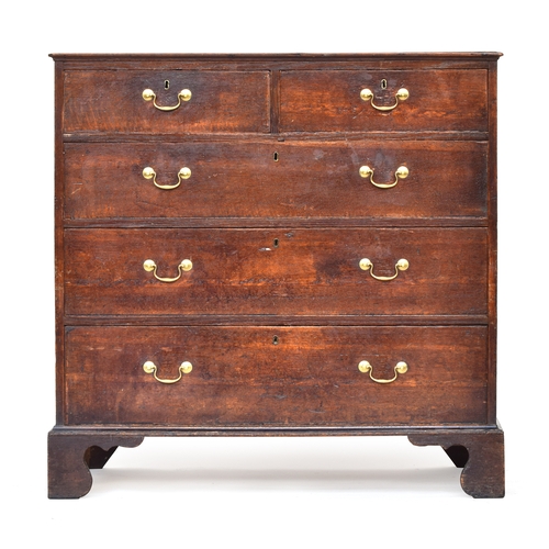 525 - A George III oak chest of drawers, the top with applied moulding, two short over three graduating dr... 