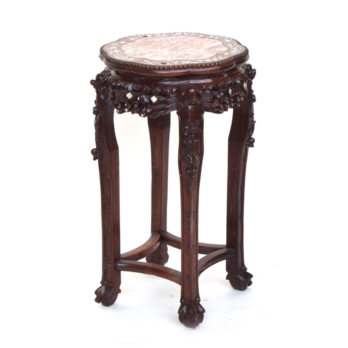 626 - A 19th century Chinese hardwood and mother of pearl jardiniere stand, with circular inset marble top... 