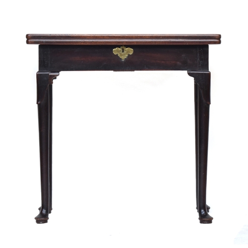 556 - A George II mahogany gateleg tea table, the hinged foldover top on lappet carved turned legs and pad... 