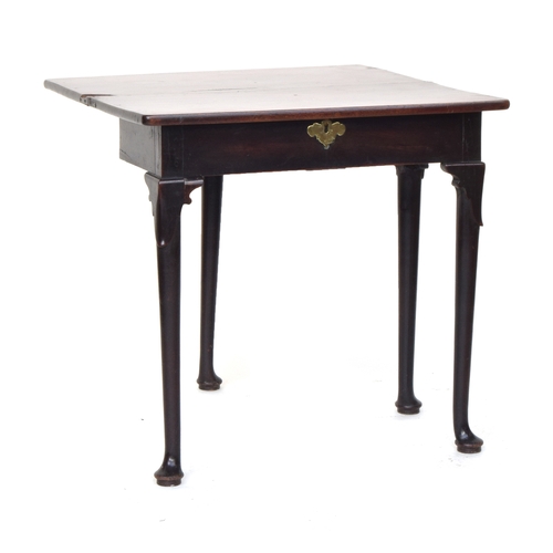 556 - A George II mahogany gateleg tea table, the hinged foldover top on lappet carved turned legs and pad... 