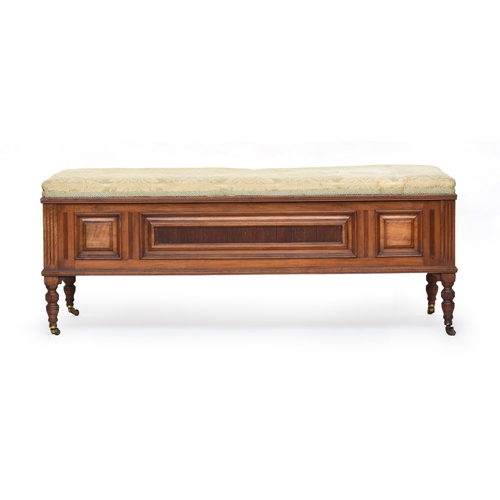 605 - A 19th century ottoman, the hinged upholstered lid over a panelled base, on turned legs with brass a... 