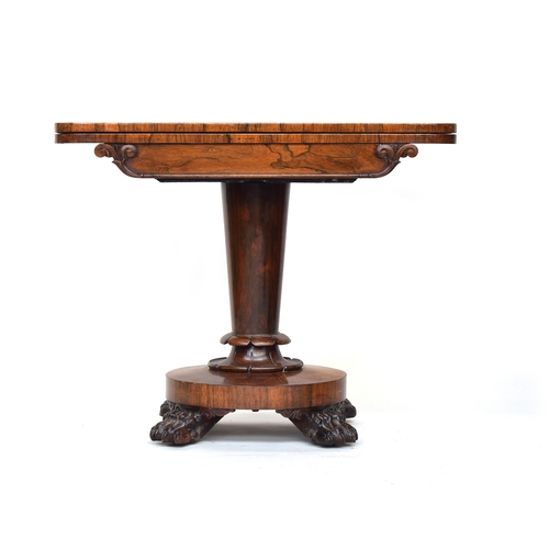 557 - A Victorian rosewood swivel top card table, on tapered turned column, circular base, and four carved... 