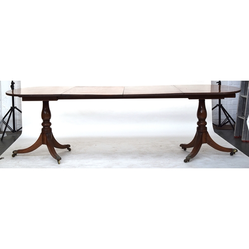 584 - A Regency D-end mahogany dining table, reeded top, on two baluster turned supports with swept legs a... 