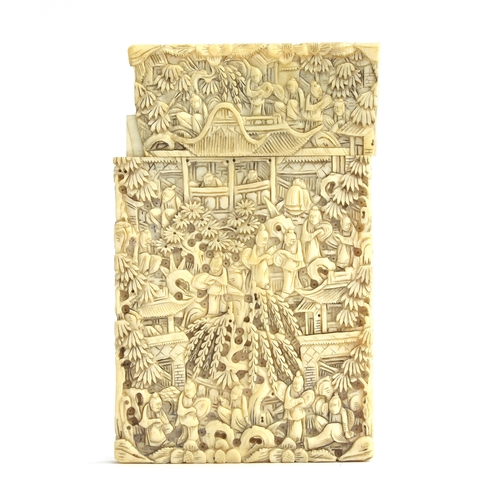 192 - A 19th century Chinese ivory card case, profusely carved with figures, foliage and court scenes, mon... 