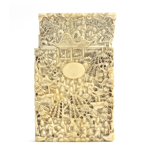 192 - A 19th century Chinese ivory card case, profusely carved with figures, foliage and court scenes, mon... 