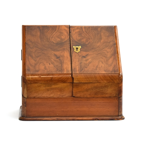 588 - A Victorian walnut sloped writing box, opening to an arrangement of letter racks, pen rest, and draw... 