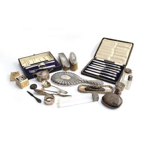 72 - A mixed lot of silver items, to include chased silver looking glass, clothes brushes, lidded mustard... 