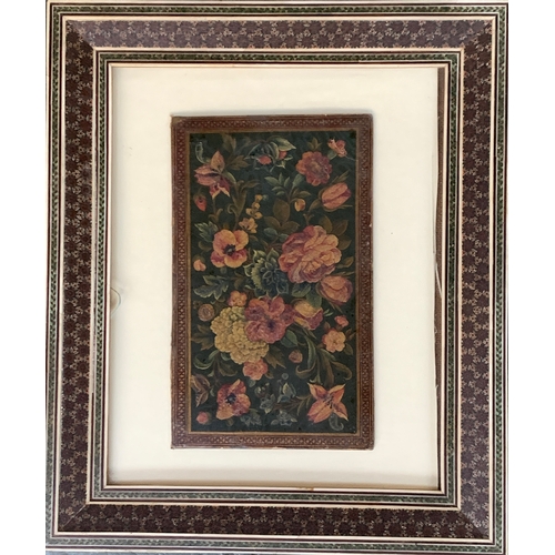 318 - A Persian Qajar lacquer binding panel, polychrome floral design, 23x14cm, in a parquetry frame, labe... 