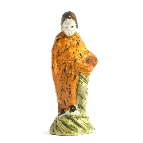 238 - An 18th century Astbury-Whieldon figure of a woman with mustard glaze dress holding flower basket, c... 