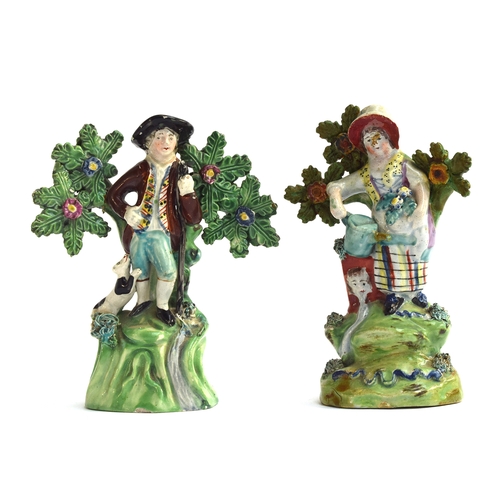 233 - Two early 19th century Staffordshire pearlware figures of gardeners, a lady gardener holding a water... 