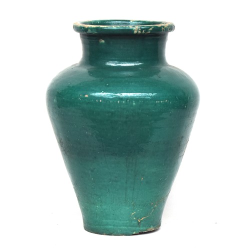 253 - A large early 20th century green glazed olive jar (af), 66cm high