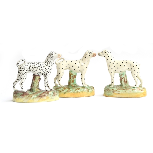 225 - A pair of Staffordshire standing dogs, with spot decoration, one with missing tail, 15.5cm high; tog... 